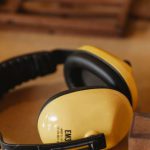 Noise-Canceling Headphones - Protective headphones for woodwork on wooden table
