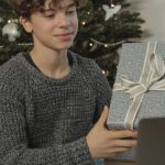 Tech Gifts - A Teenage Boy Showing a Gift Via Video Call