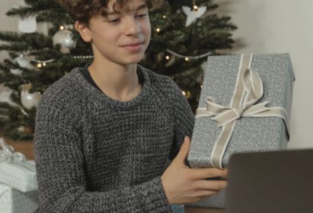 Tech Gifts - A Teenage Boy Showing a Gift Via Video Call
