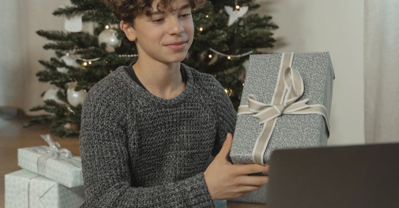Tech Gifts - A Teenage Boy Showing a Gift Via Video Call