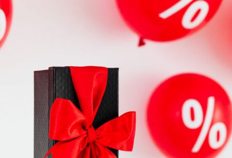 Discounts - Present With Balloons On The Background