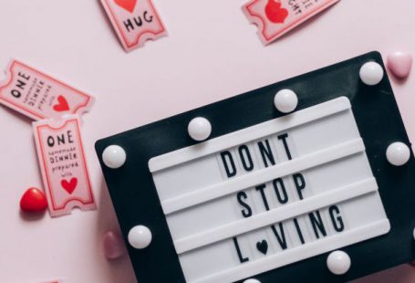 Coupons - Flat Lay of Don't Stop Loving Sign Surrounded by Movie Coupons