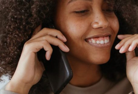 Smartphone - A Woman Wearing a Brown Sweater on a Phone Call