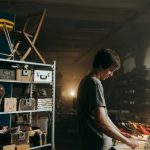 Resale - Man in Gray T-shirt Standing in Front of Table