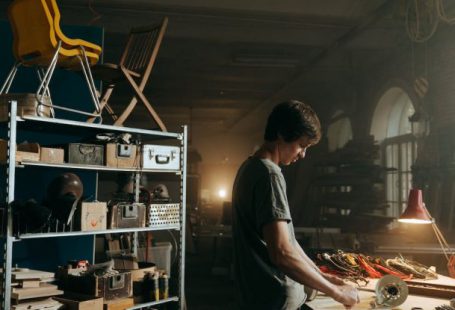 Resale - Man in Gray T-shirt Standing in Front of Table