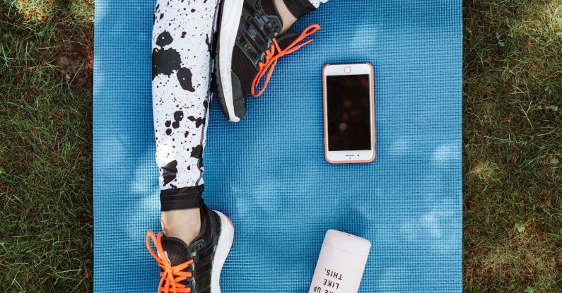 Smartphone - A Person's Legs on Yoga Mat