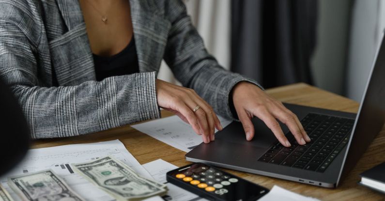 Budget Laptops - A Woman in Plaid Blazer Using Her Laptop