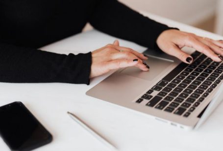 Data Plans - Crop faceless woman working on netbook in office