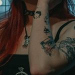 Alternatives - Woman in Black Tank Top With Tattoo on Her Left Hand