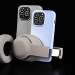 Pair of smartphones with beige headphones on black background, showcasing modern technology.