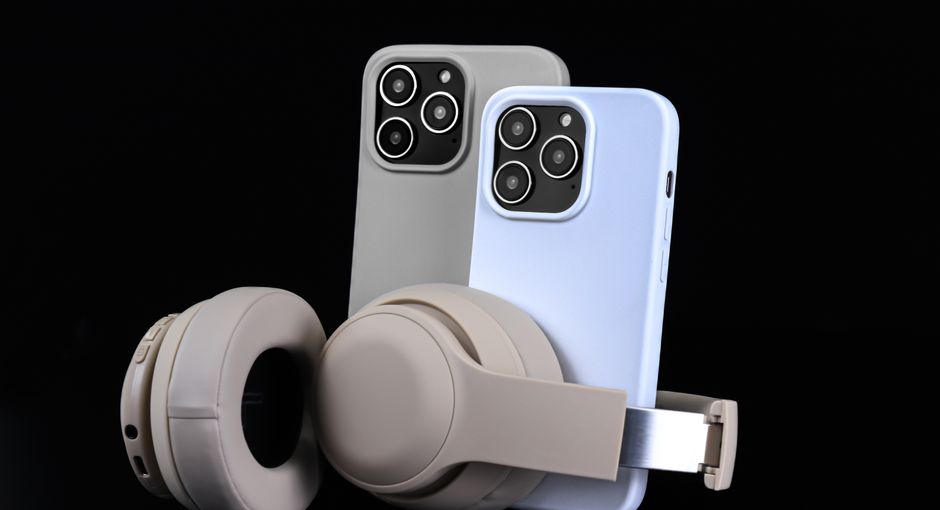 Pair of smartphones with beige headphones on black background, showcasing modern technology.